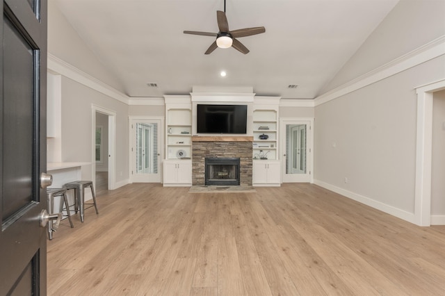 1101 Maple Ridge Way, Greensboro, GA 30642 - unfurnished living room with a ceiling fan, vaulted ceiling, a stone fireplace, and light wood-style flooring