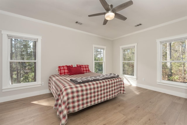 bedroom featuring crown molding, ceiling fan, and light hardwood / wood-style floors