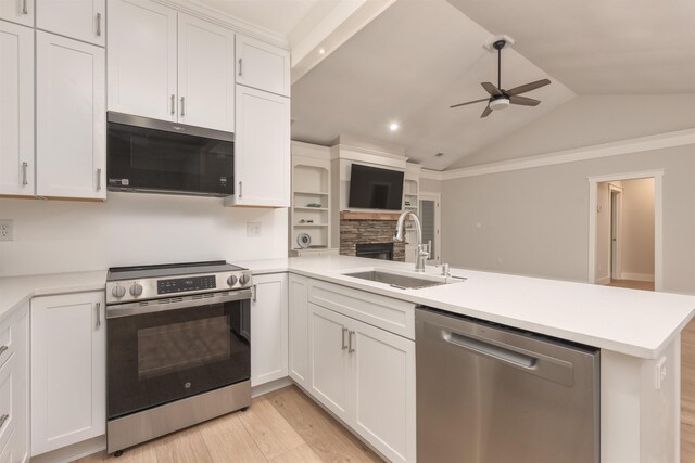1101 Maple Ridge Way, Greensboro, GA 30642 - kitchen featuring a peninsula, ceiling fan, a sink, appliances with stainless steel finishes, and vaulted ceiling