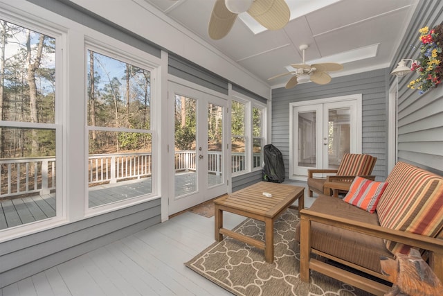 sunroom featuring ceiling fan, french doors, and a healthy amount of sunlight