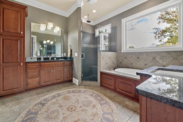 bathroom with vanity, crown molding, tasteful backsplash, and independent shower and bath