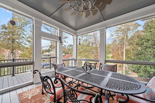 sunroom / solarium featuring ceiling fan