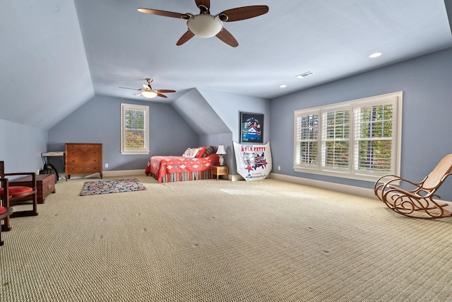 bedroom with multiple windows, lofted ceiling, carpet flooring, and ceiling fan