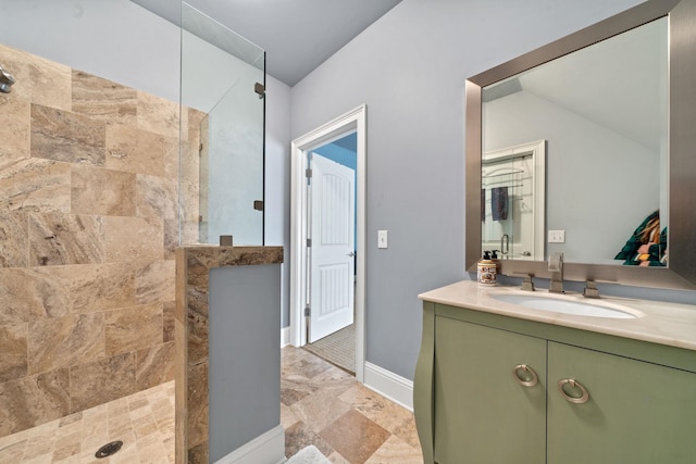 bathroom featuring a tile shower and vanity