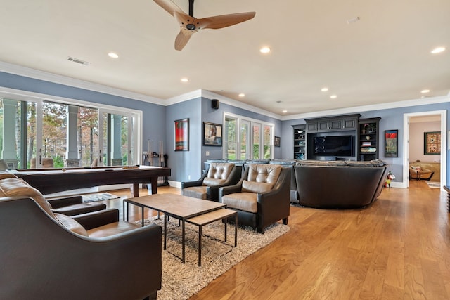 living room featuring ornamental molding, ceiling fan, and light hardwood / wood-style floors