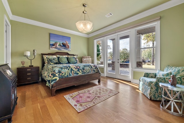 bedroom with access to exterior, crown molding, french doors, and light wood-type flooring