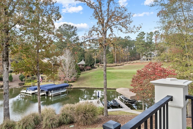 dock area featuring a lawn and a water view