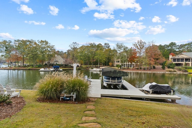 dock area featuring a lawn and a water view