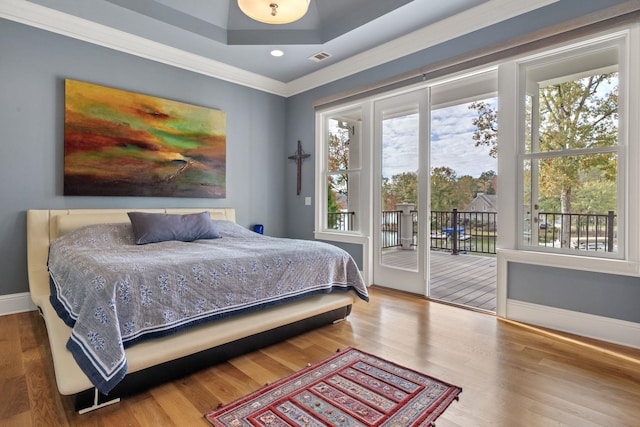 bedroom featuring access to exterior, hardwood / wood-style flooring, and ornamental molding