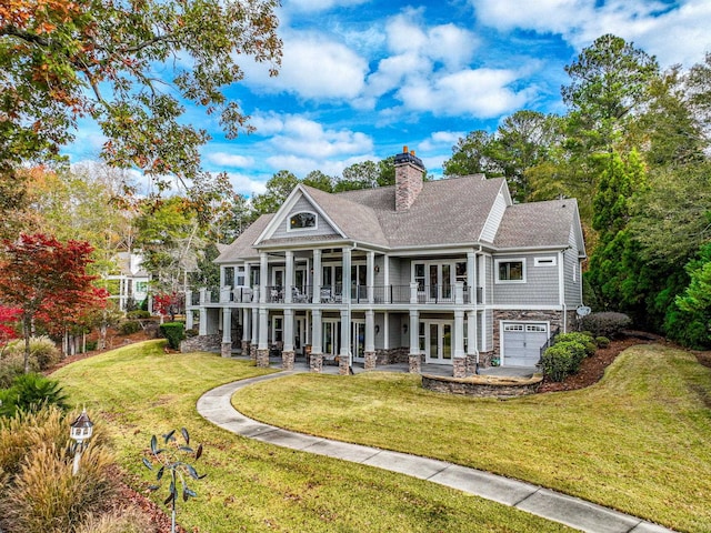 back of property with a patio, a yard, a garage, and french doors