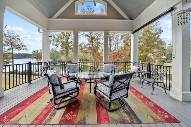 wooden terrace featuring a water view