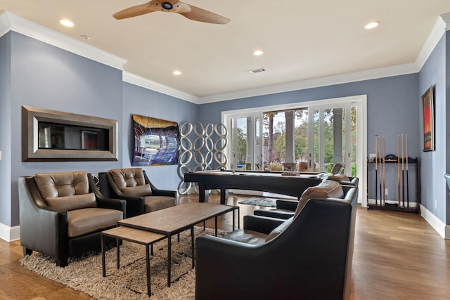 living room with crown molding, ceiling fan, and light hardwood / wood-style floors