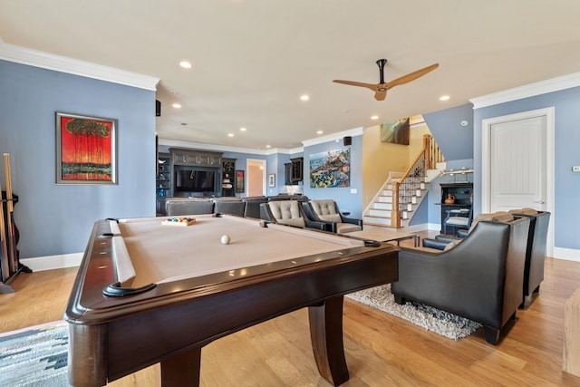 rec room with crown molding, ceiling fan, and light hardwood / wood-style floors