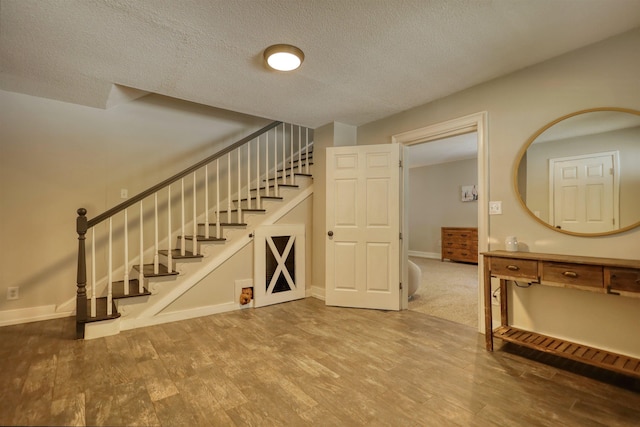 222 River Bend Dr, Eatonton, GA 31024 - stairway featuring wood finished floors and a textured ceiling