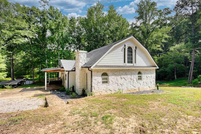 222 River Bend Dr, Eatonton, GA 31024 - view of front of house featuring stone siding, a porch, roof with shingles, a front lawn, and view of scattered trees