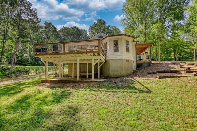 222 River Bend Dr, Eatonton, GA 31024 - back of property with a yard, a deck, and view of wooded area