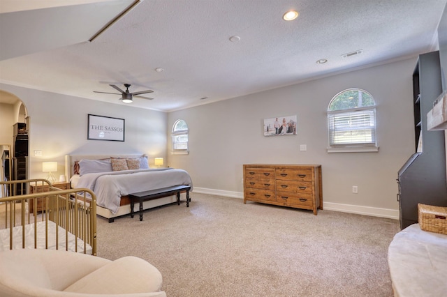 222 River Bend Dr, Eatonton, GA 31024 - bedroom featuring arched walkways, multiple windows, light colored carpet, recessed lighting, and a textured ceiling