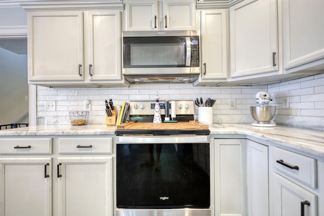 222 River Bend Dr, Eatonton, GA 31024 - kitchen with stainless steel appliances, decorative backsplash, and light stone counters