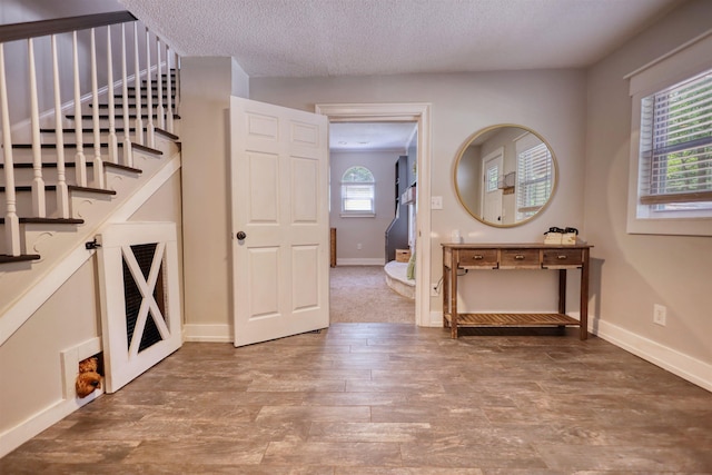 222 River Bend Dr, Eatonton, GA 31024 - foyer entrance with a textured ceiling, wood finished floors, and stairway