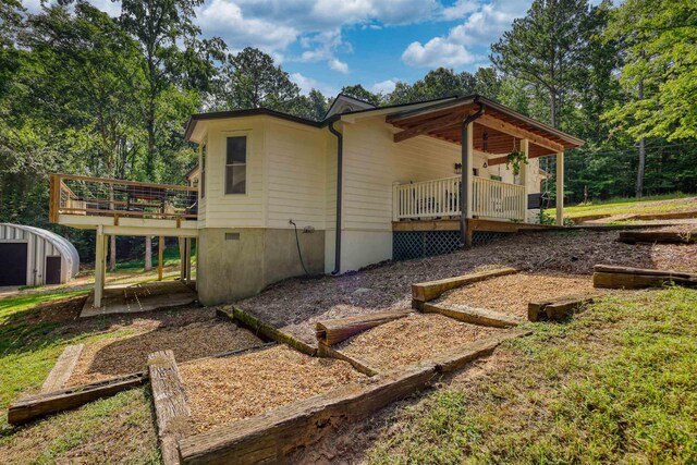 222 River Bend Dr, Eatonton, GA 31024 - view of side of property with a wooden deck and a storage unit