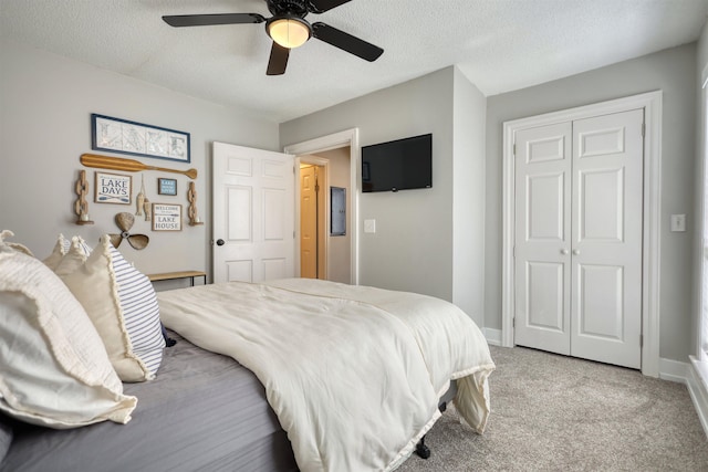 222 River Bend Dr, Eatonton, GA 31024 - bedroom with light colored carpet, a textured ceiling, a ceiling fan, and a closet