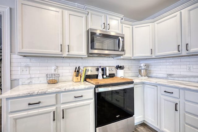 222 River Bend Dr, Eatonton, GA 31024 - kitchen featuring appliances with stainless steel finishes, decorative backsplash, light stone counters, and white cabinetry