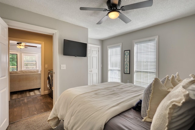 222 River Bend Dr, Eatonton, GA 31024 - carpeted bedroom featuring a textured ceiling, a ceiling fan, and washing machine and dryer