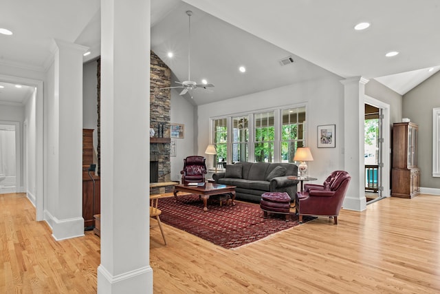living area featuring light wood-type flooring, recessed lighting, baseboards, a stone fireplace, and ceiling fan