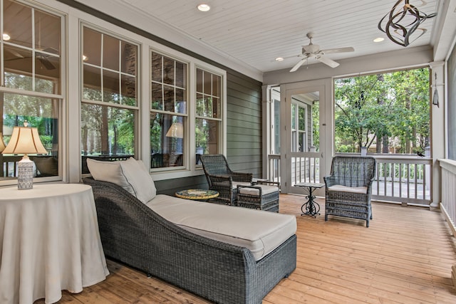 sunroom / solarium featuring a ceiling fan