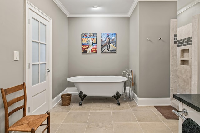 full bathroom with ornamental molding, a freestanding tub, baseboards, and tile patterned floors