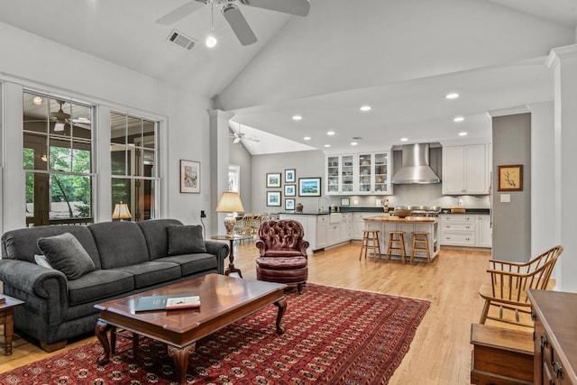 living room featuring a ceiling fan, light wood-style flooring, recessed lighting, and high vaulted ceiling