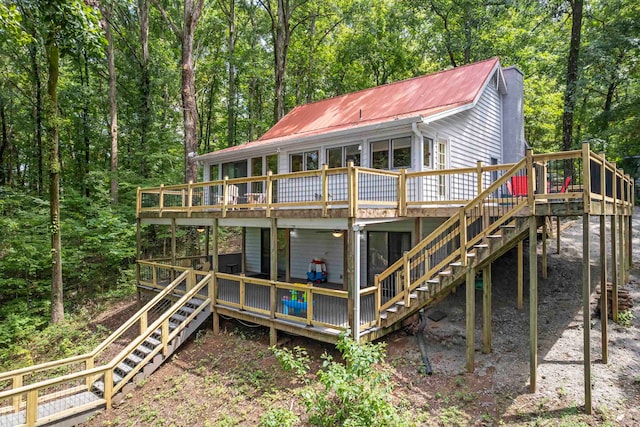 rear view of property featuring a wooden deck