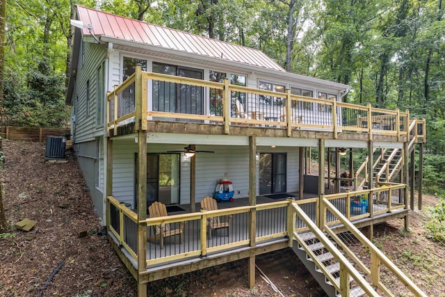 rear view of house featuring a wooden deck, ceiling fan, and central AC unit