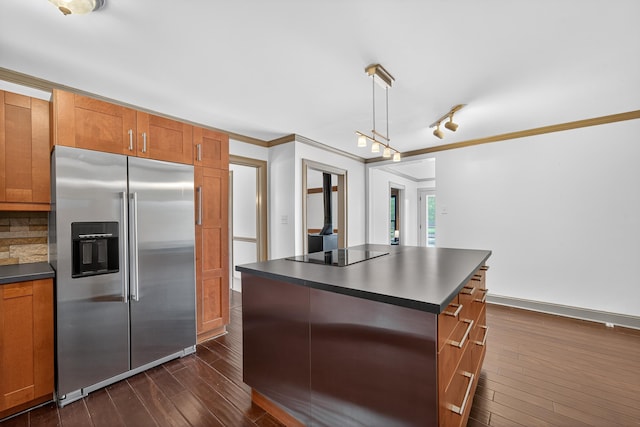 128 Turtle Ct, Eatonton, GA 31024 - kitchen with high end fridge, dark countertops, dark wood-type flooring, brown cabinetry, and crown molding