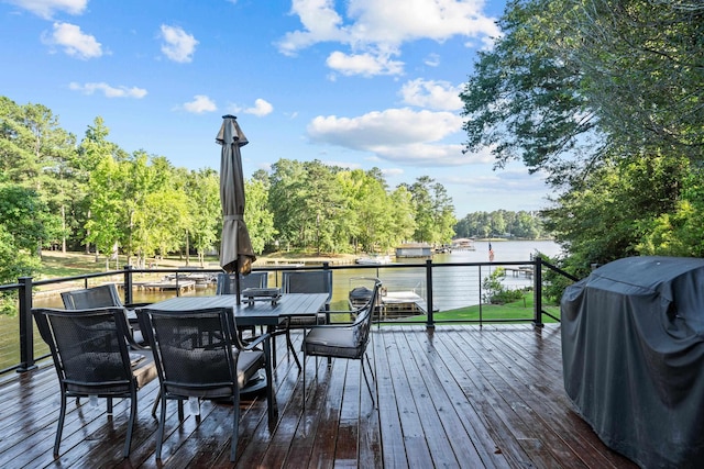 128 Turtle Ct, Eatonton, GA 31024 - wooden terrace with a water view, area for grilling, outdoor dining space, and view of scattered trees