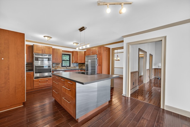 128 Turtle Ct, Eatonton, GA 31024 - kitchen featuring stainless steel appliances, dark countertops, brown cabinets, and dark wood-type flooring