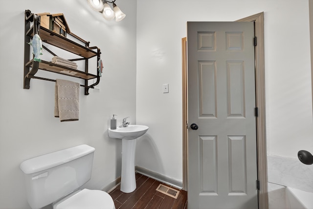 128 Turtle Ct, Eatonton, GA 31024 - bathroom with toilet and wood finished floors