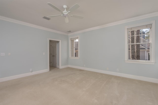 unfurnished room with crown molding, light colored carpet, and ceiling fan