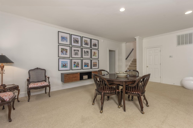 carpeted dining area with crown molding