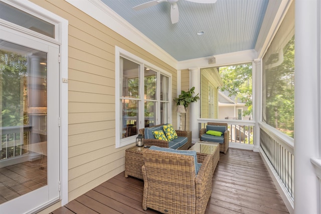 sunroom featuring ceiling fan