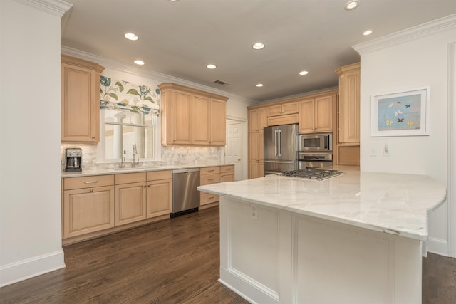 kitchen featuring light brown cabinetry, sink, stainless steel appliances, and kitchen peninsula