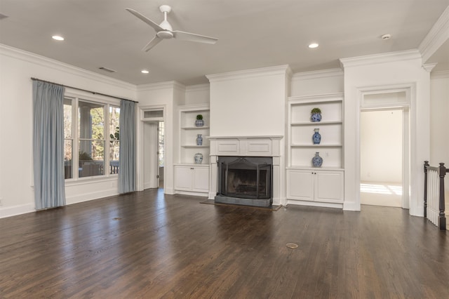 unfurnished living room featuring crown molding, built in shelves, dark hardwood / wood-style floors, and ceiling fan