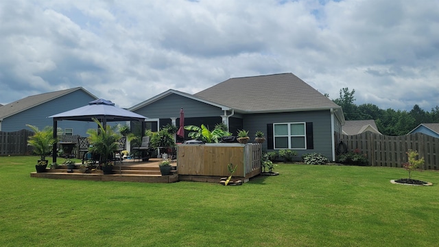  - rear view of house featuring a gazebo, a deck, and roof with shingles