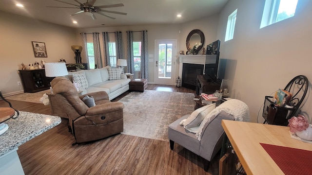  - living area with recessed lighting, wood finished floors, a ceiling fan, and a glass covered fireplace