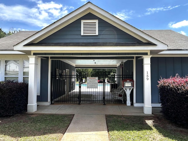  - doorway to property featuring roof with shingles and board and batten siding