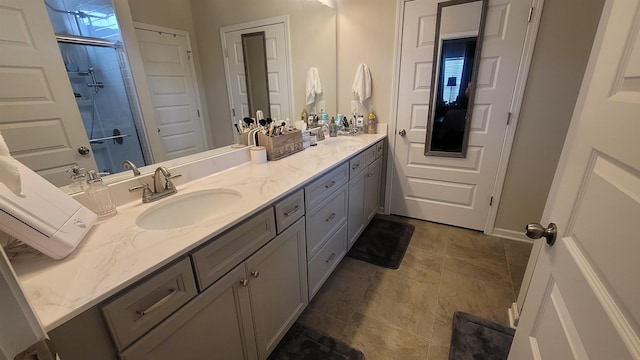  - bathroom with double vanity and a tile shower