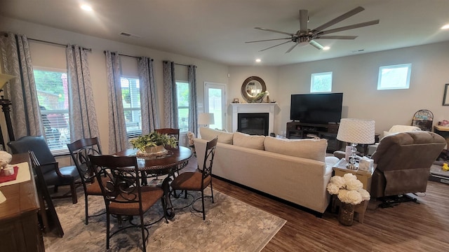  - living area featuring wood finished floors, a glass covered fireplace, recessed lighting, and ceiling fan
