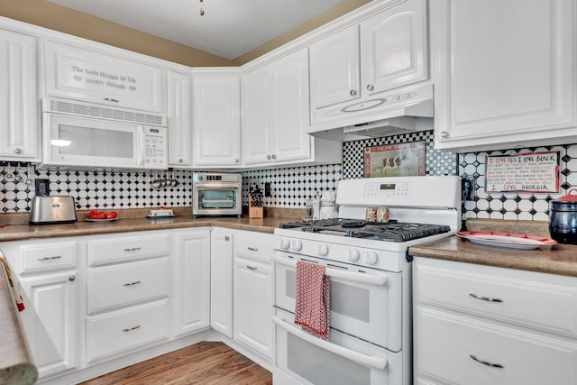 kitchen with white cabinetry, white appliances, and decorative backsplash