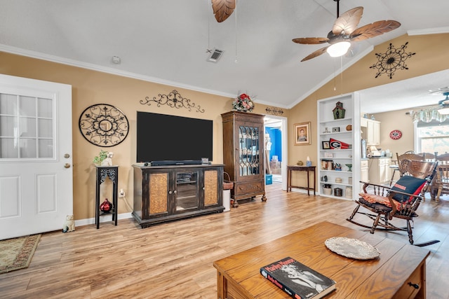 living room with ornamental molding, light hardwood / wood-style floors, ceiling fan, and vaulted ceiling