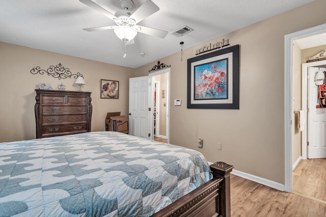 bedroom with ceiling fan and light hardwood / wood-style floors